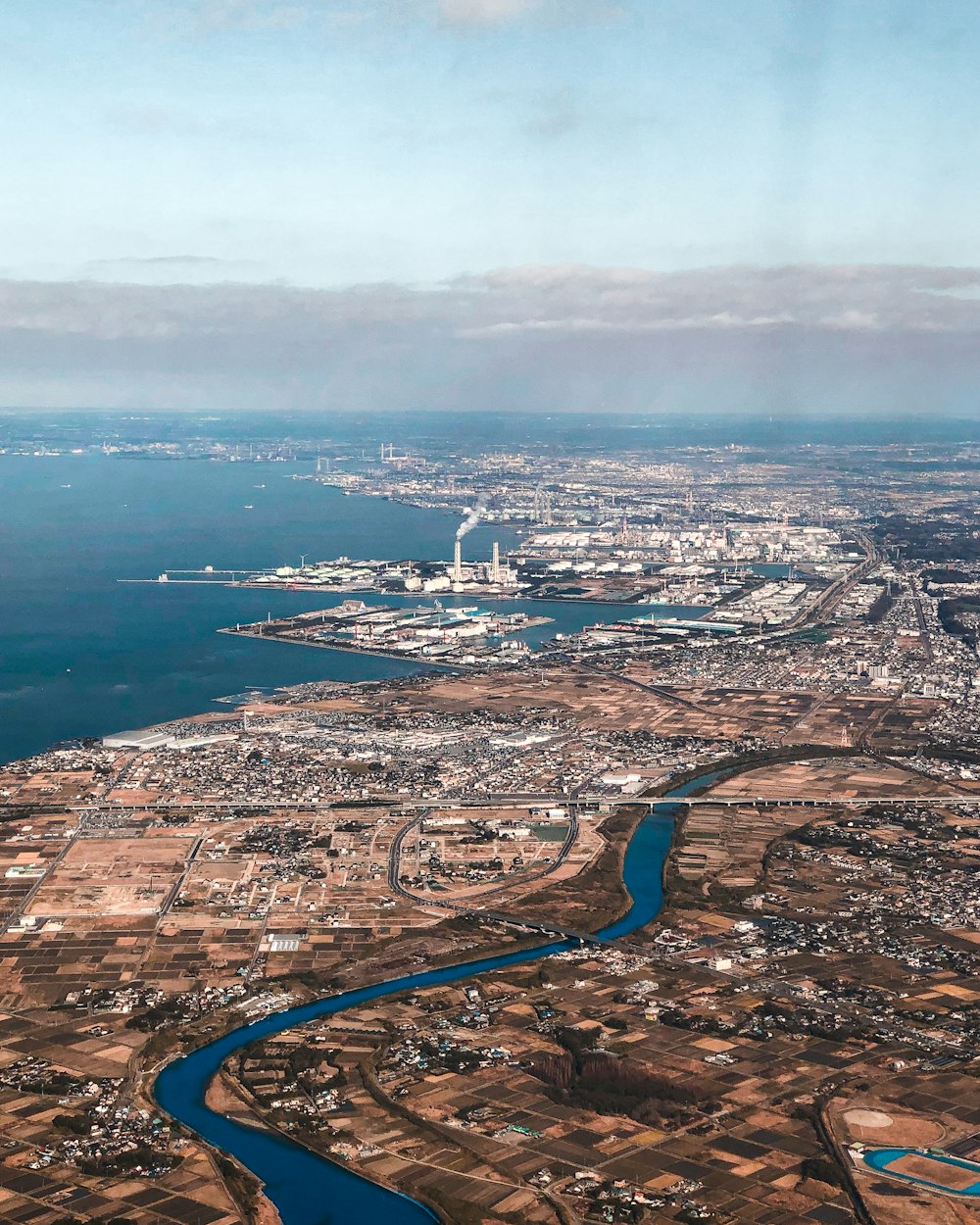 aerial view of city near body of water during daytime