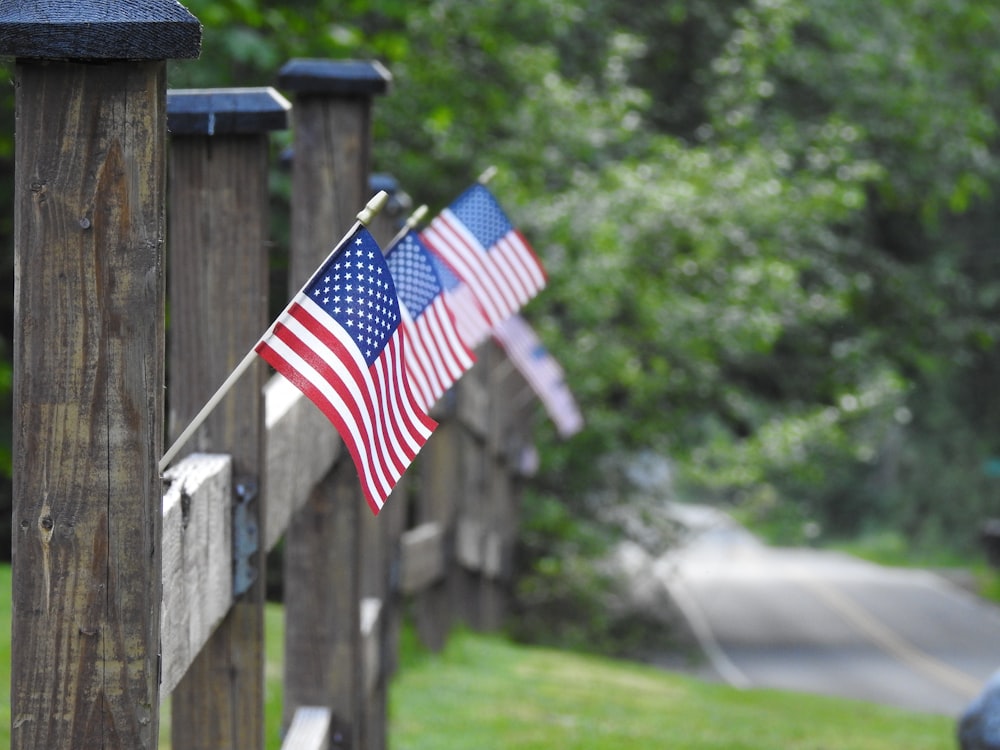 us a flag on wooden fence