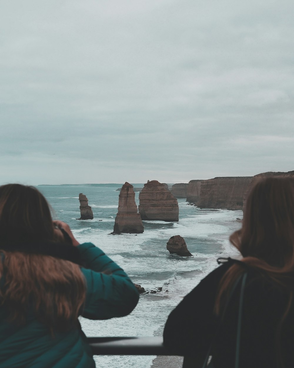 a couple of people that are looking at the ocean