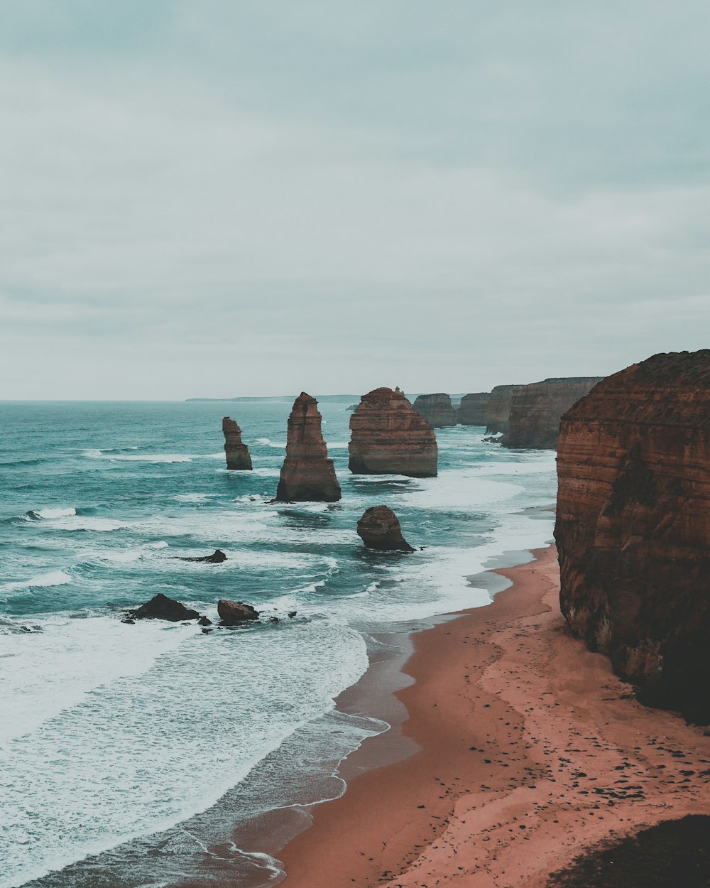 brown rock formation on sea shore during daytime