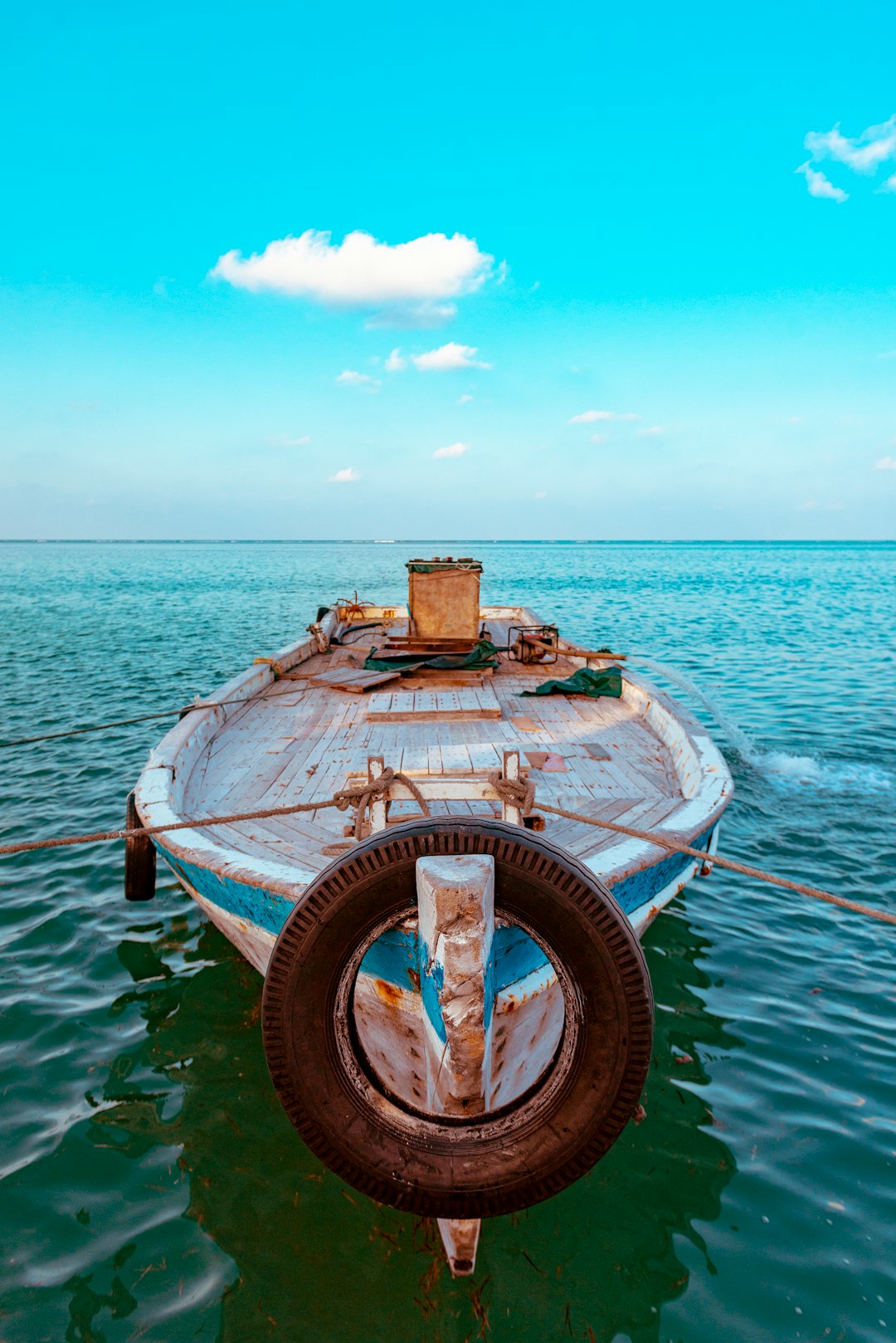 green boat on body of water during daytime