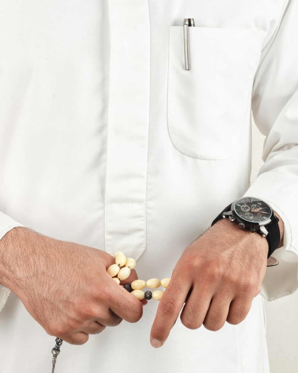 man in white dress shirt wearing black round analog watch