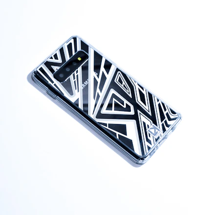 Close-up of a sleek smartphone case with vibrant colors on a wooden table.