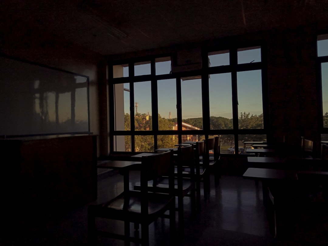 brown wooden table and chairs near window,