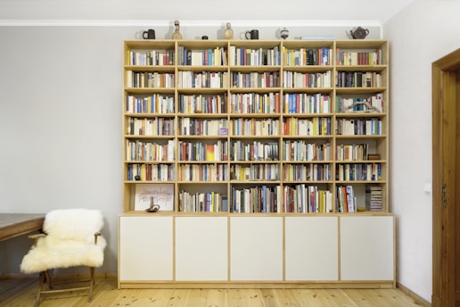 books on white wooden shelf