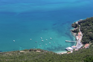 A scenic view of Ierapetra coastline with turquoise waters and boats docked.