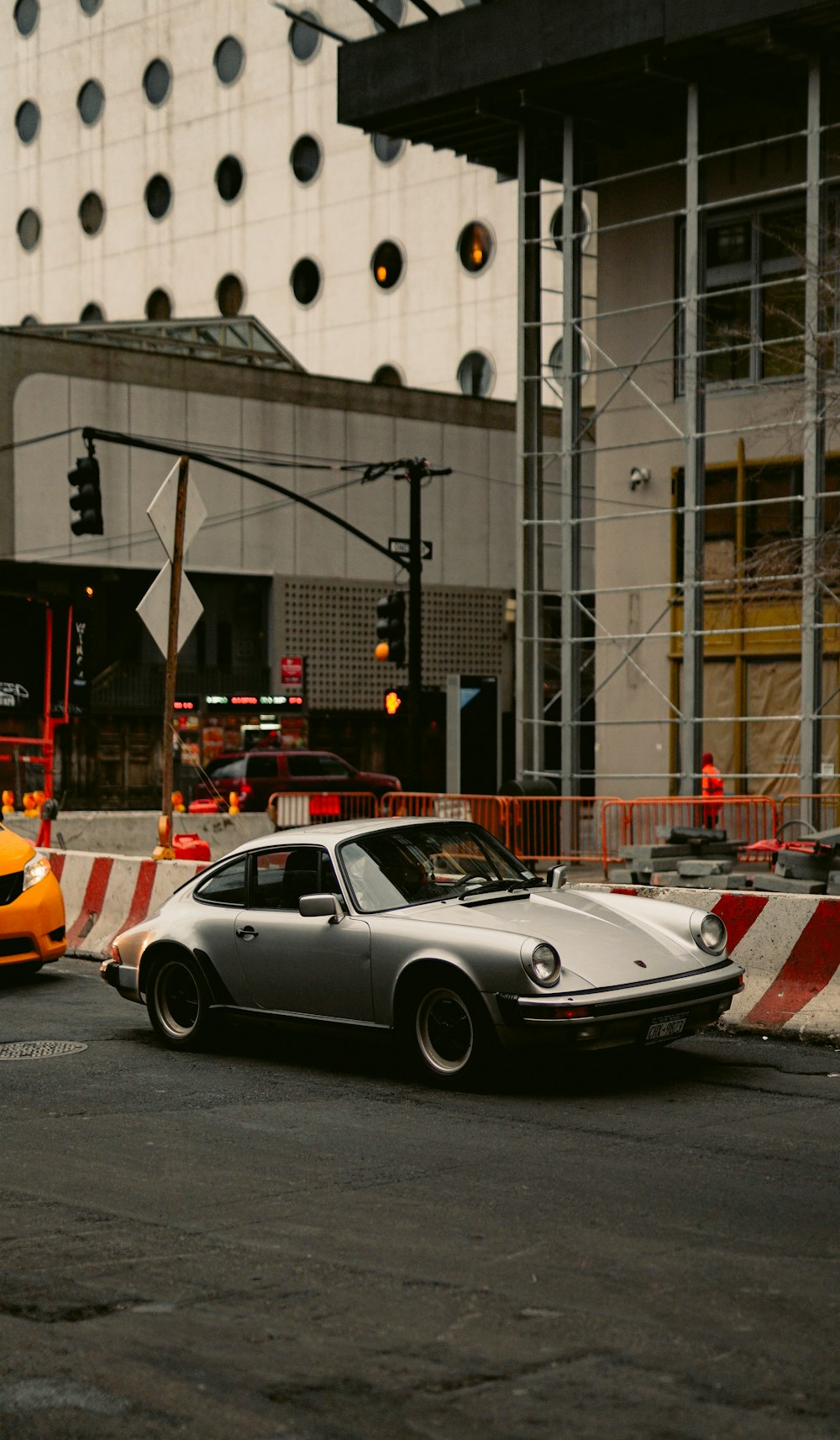 silver porsche 911 parked on street during daytime