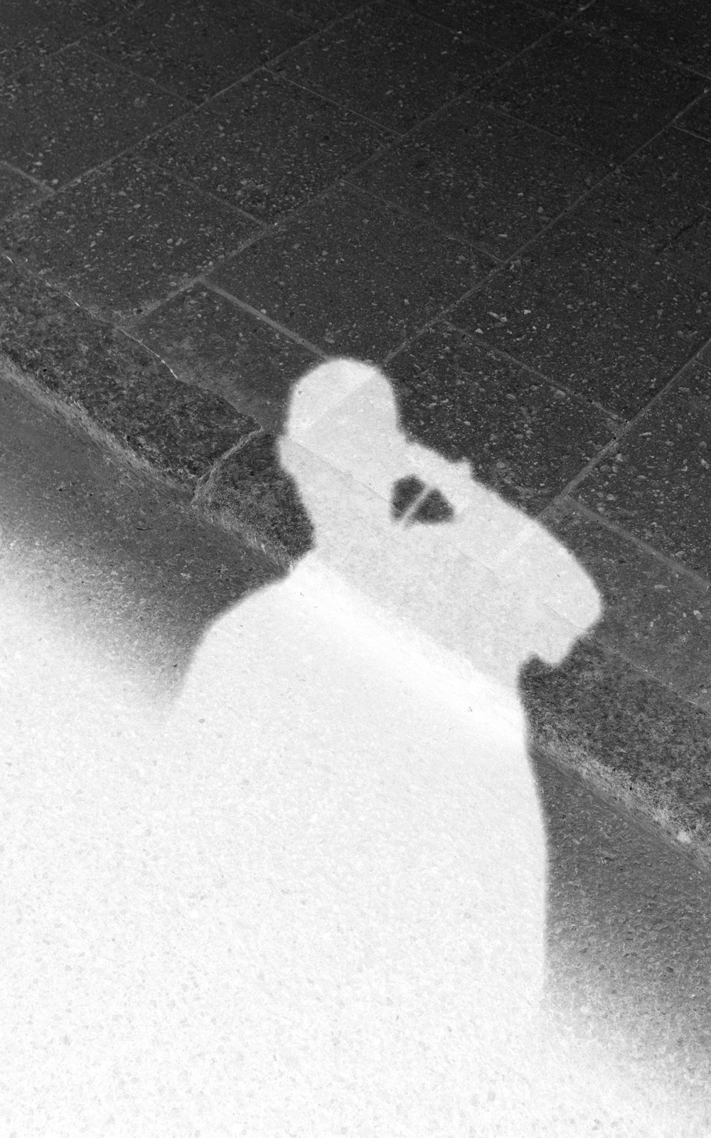 shadow of person on gray concrete floor
