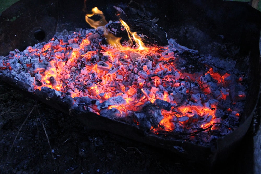 brown and red fire on black metal fire pit