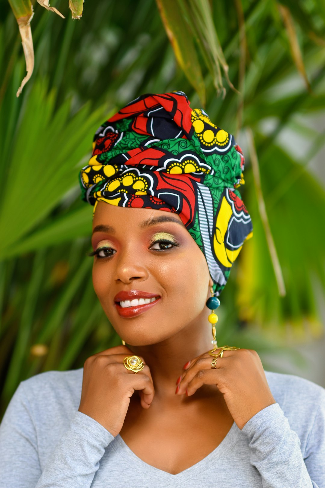 woman in white tank top wearing blue and yellow floral headdress