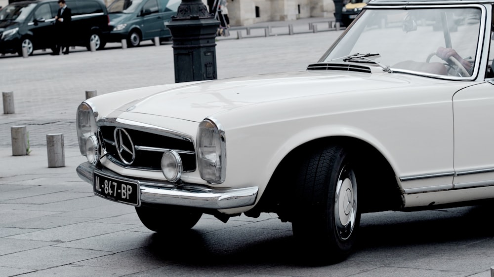 white classic car on road during daytime