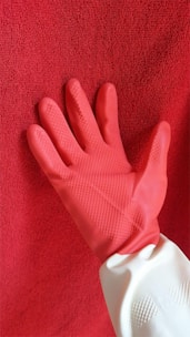 persons left hand on red textile