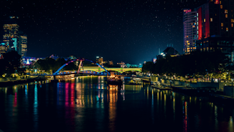 lighted bridge over river during night time