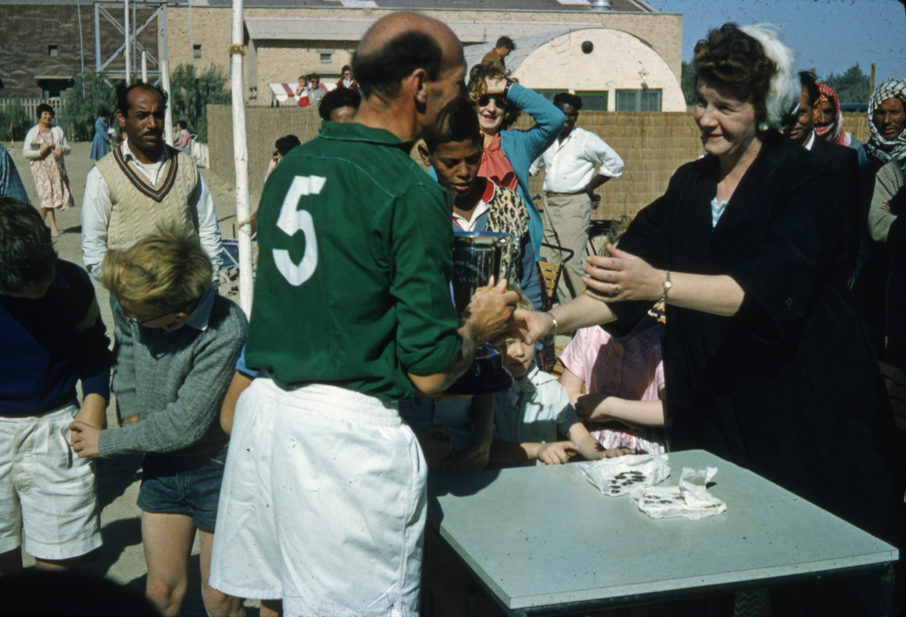 people standing near green table during daytime kuwait teams background