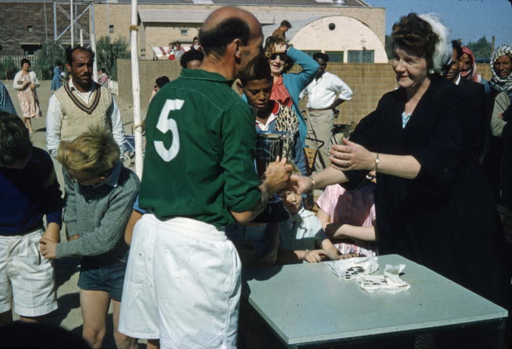 people standing near green table during daytime