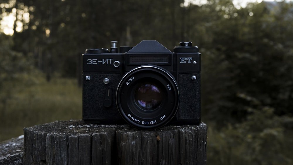 black nikon dslr camera on brown wooden surface