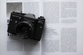 black and silver nikon dslr camera on white printer paper