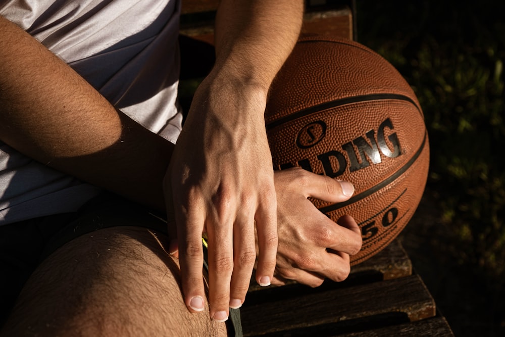 person in white shirt holding basketball