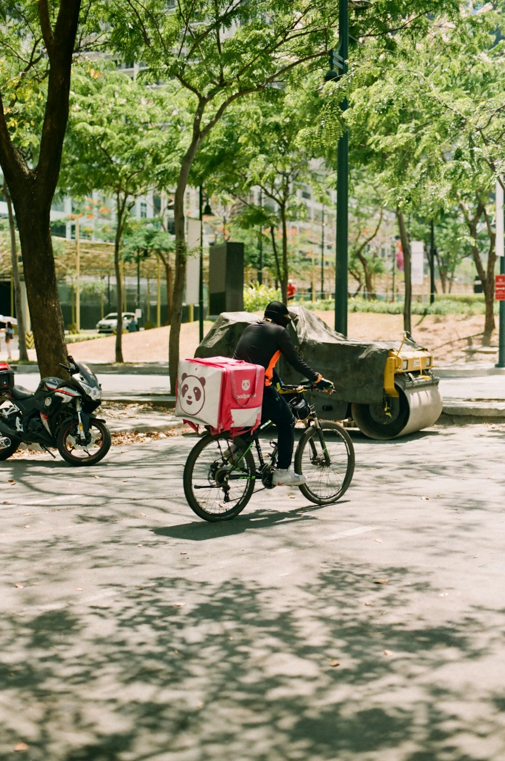 man in gray jacket riding on black and red motorcycle during daytime