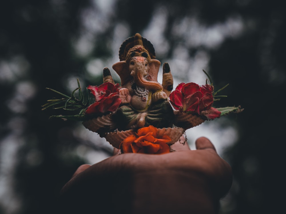 person holding red roses in tilt shift lens