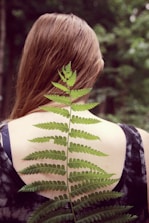 woman in black and white tank top with green leaf on her back