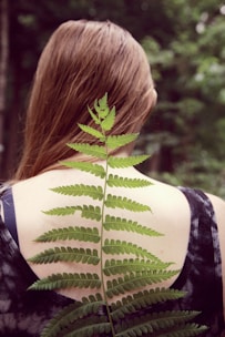 woman in black and white tank top with green leaf on her back
