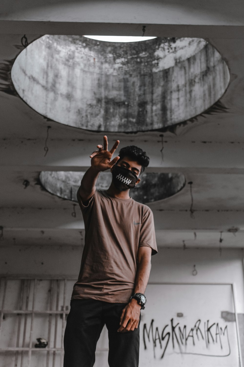 man in white crew neck t-shirt wearing black hat