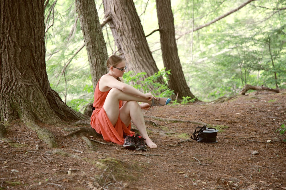 woman in orange dress sitting on ground