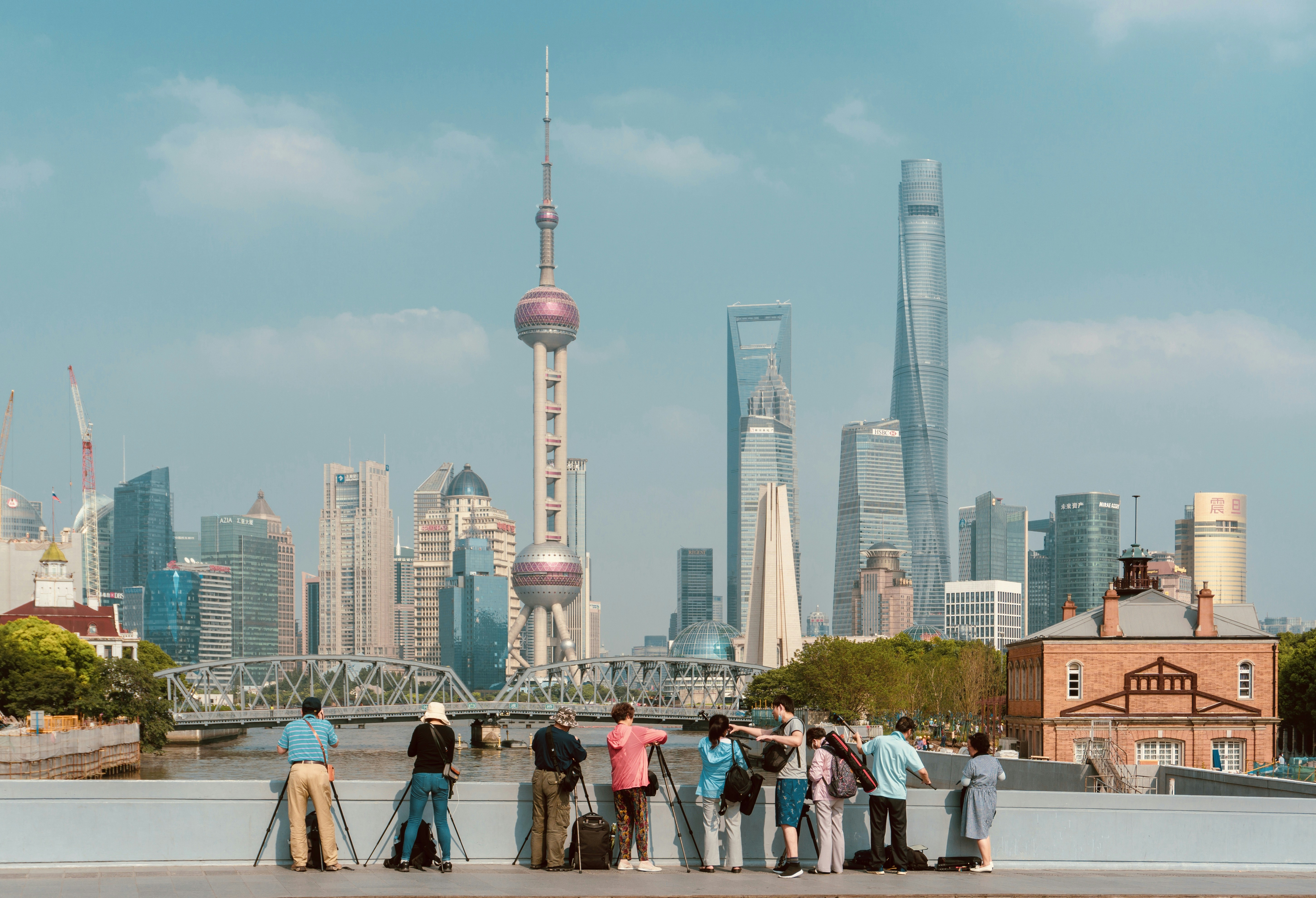 people standing near high rise buildings during daytime