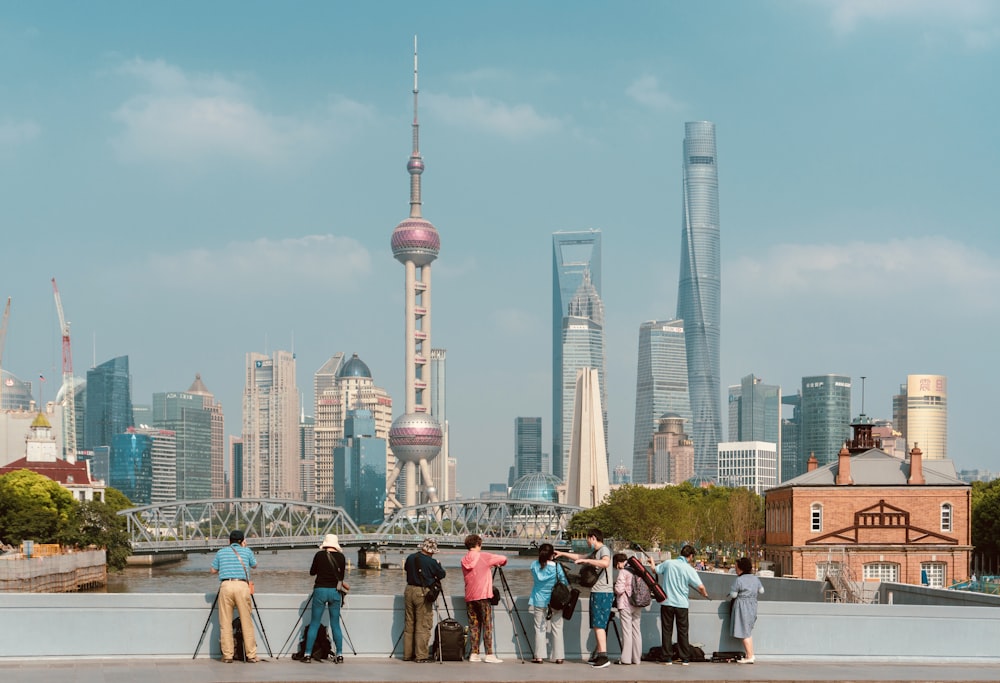 people standing near high rise buildings during daytime