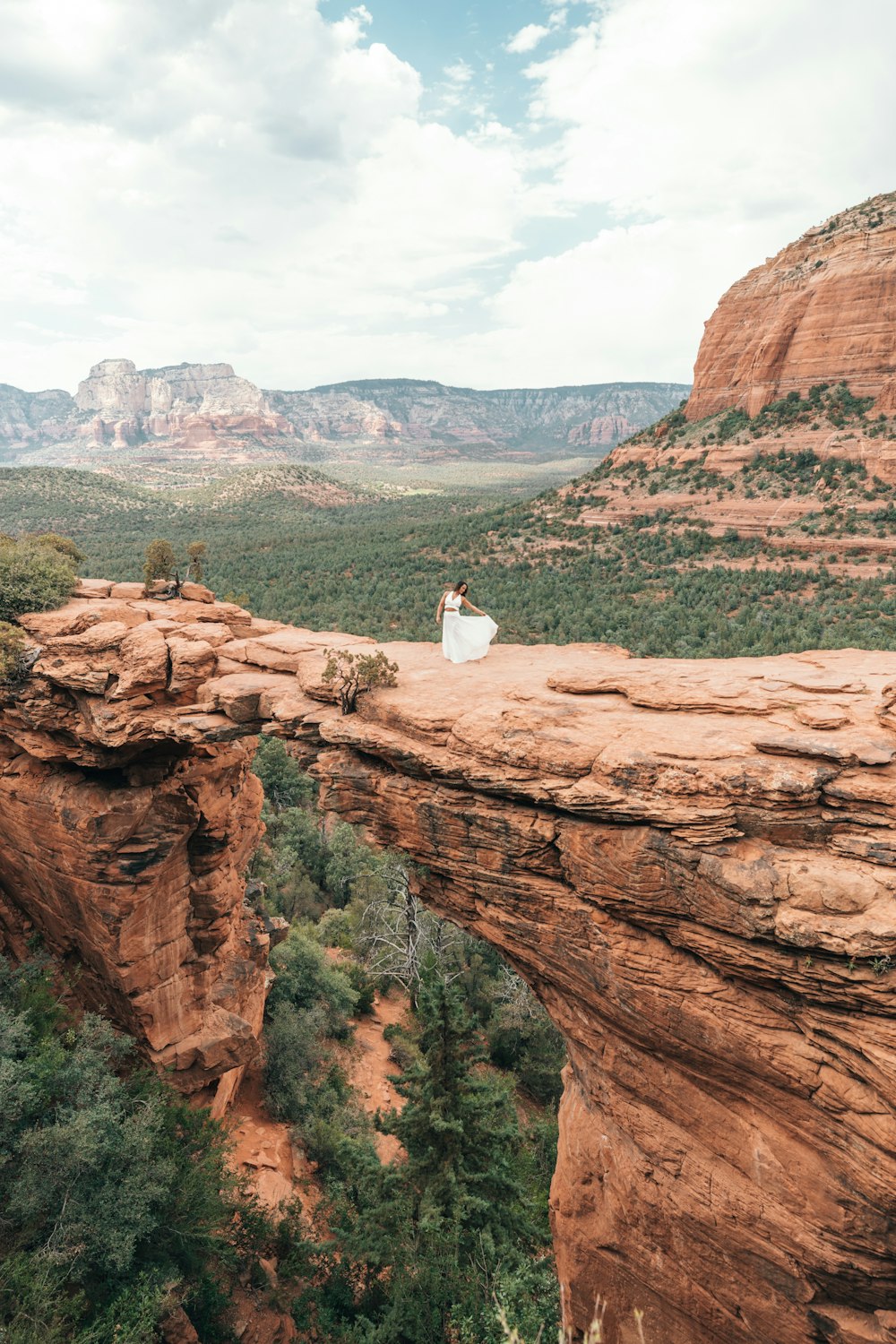 person sitting on brown rock formation during daytime