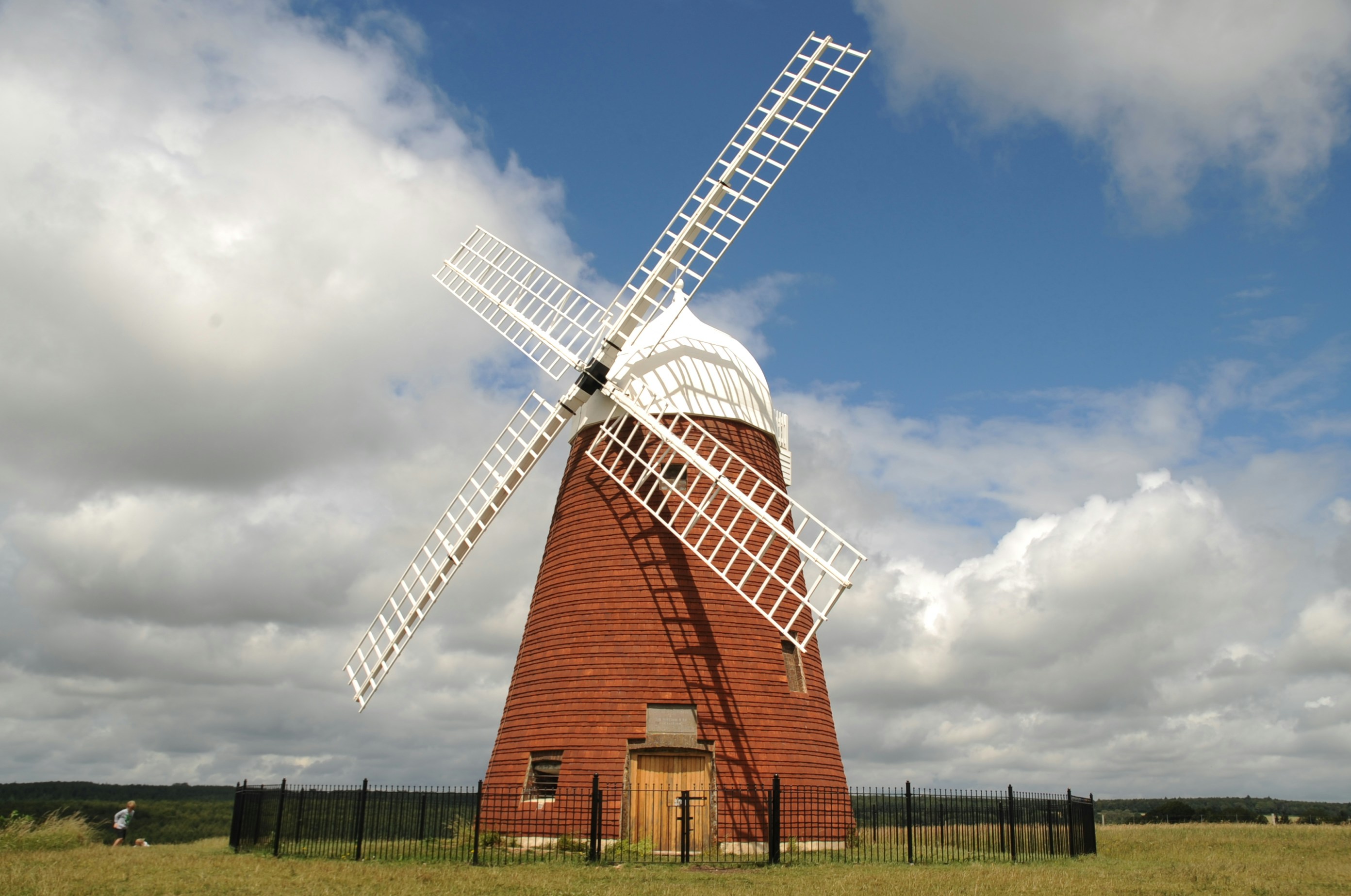 brown and white windmill under blue sky during daytime