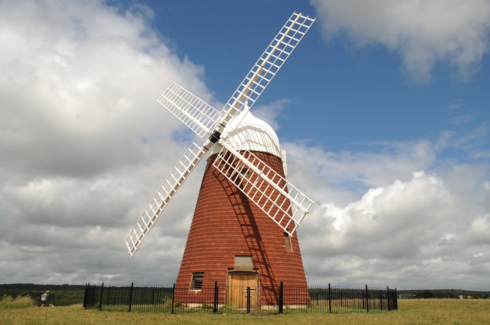 brown and white windmill under blue sky during daytime