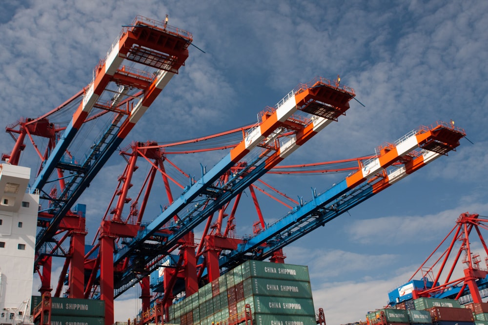 red and blue crane under blue sky during daytime