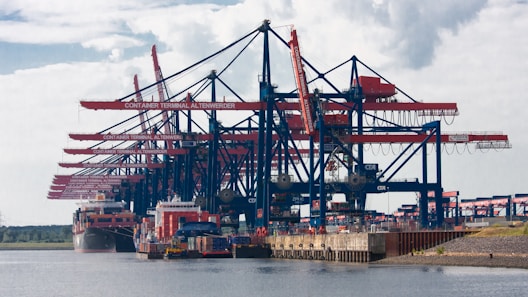 red and blue cargo ship on sea during daytime