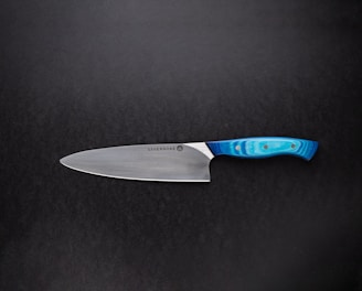 red handled knife on black surface