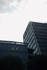Contemporary office tower with reflective windows in urban setting.