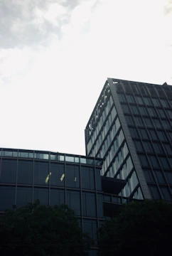 Contemporary office tower with reflective windows in urban setting.