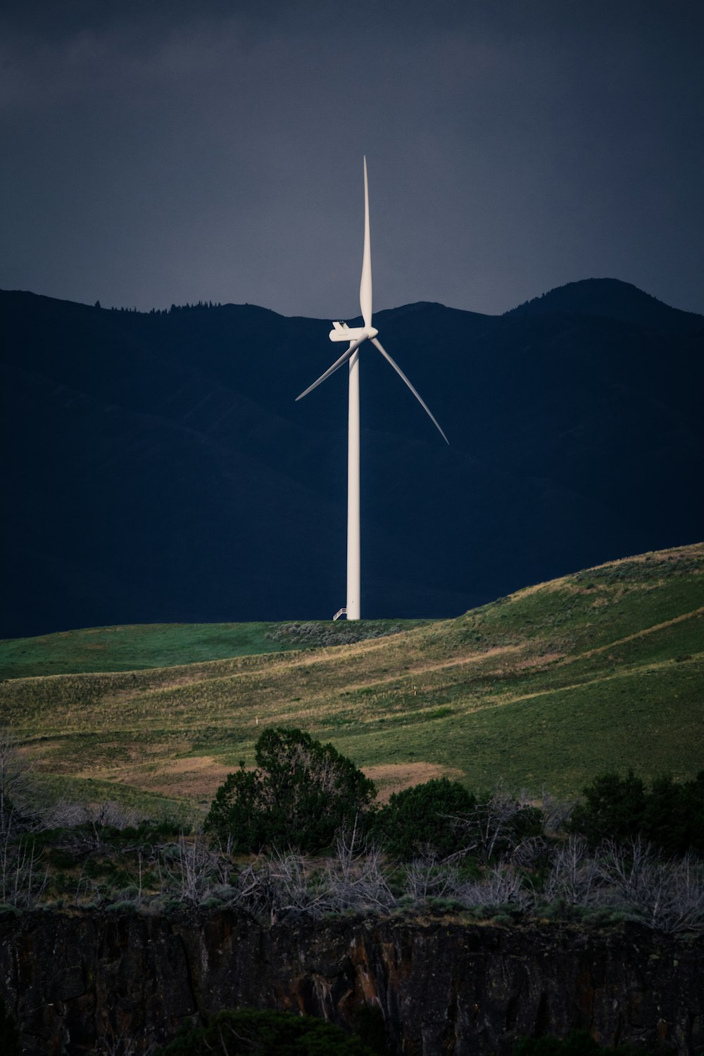 white wind turbine on green grass field during daytime