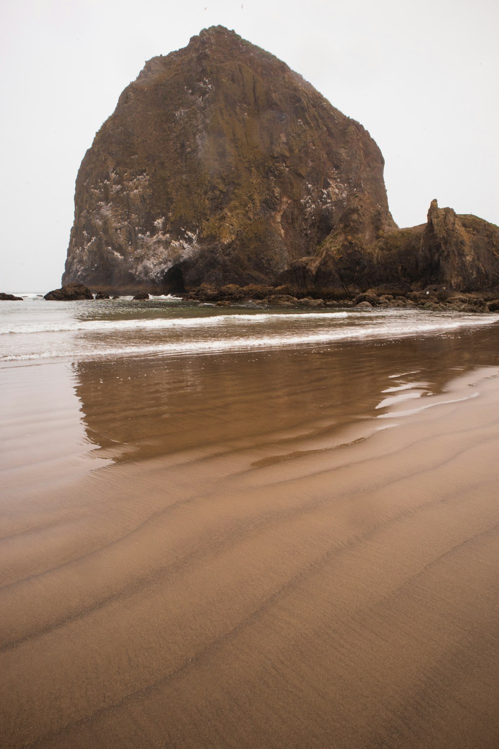 brown rock formation on sea shore during daytime