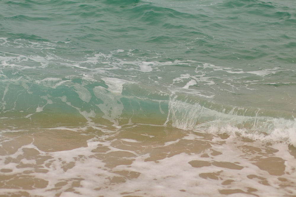 sea waves on beach shore during daytime