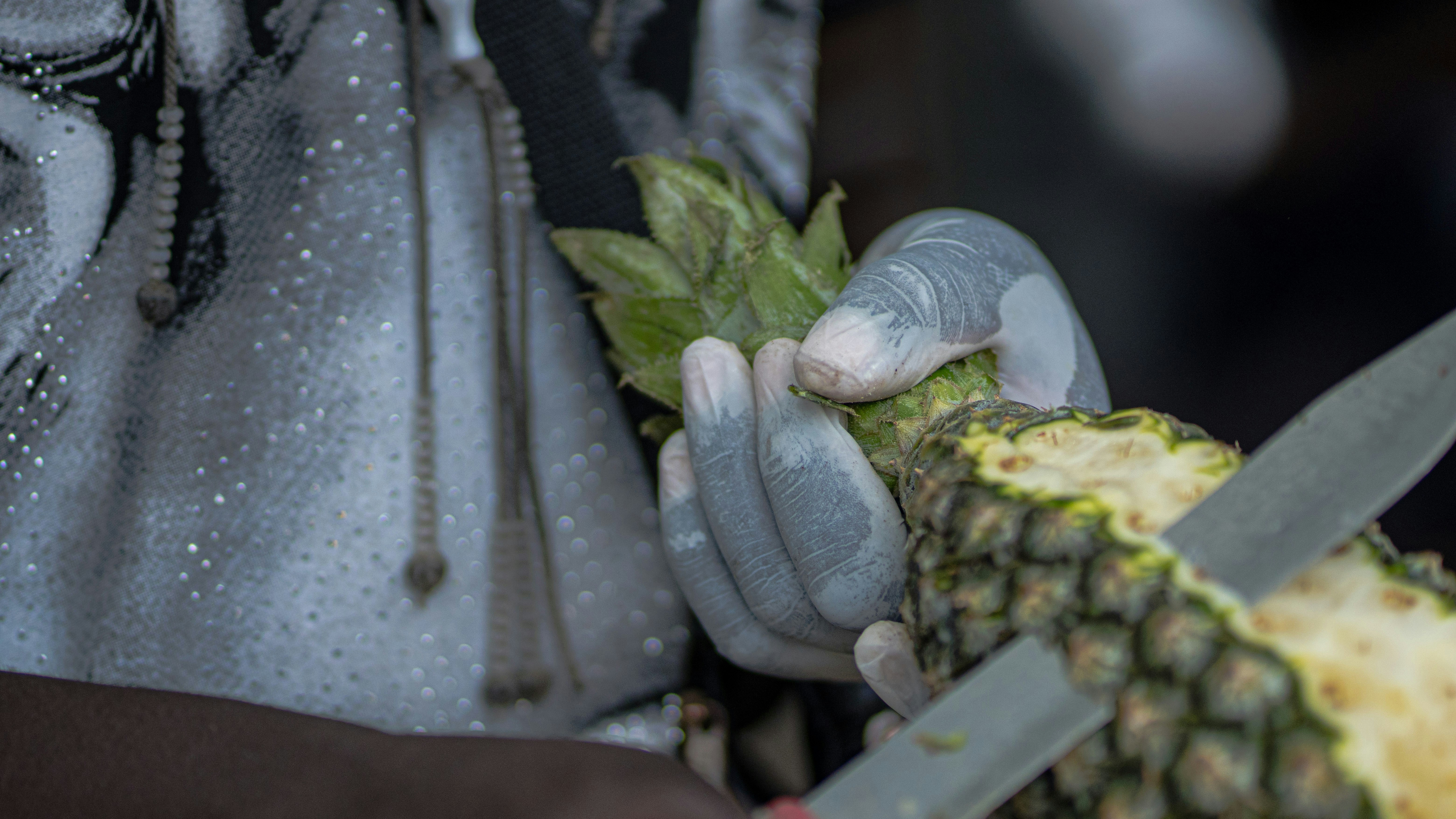 person holding green and brown fruit