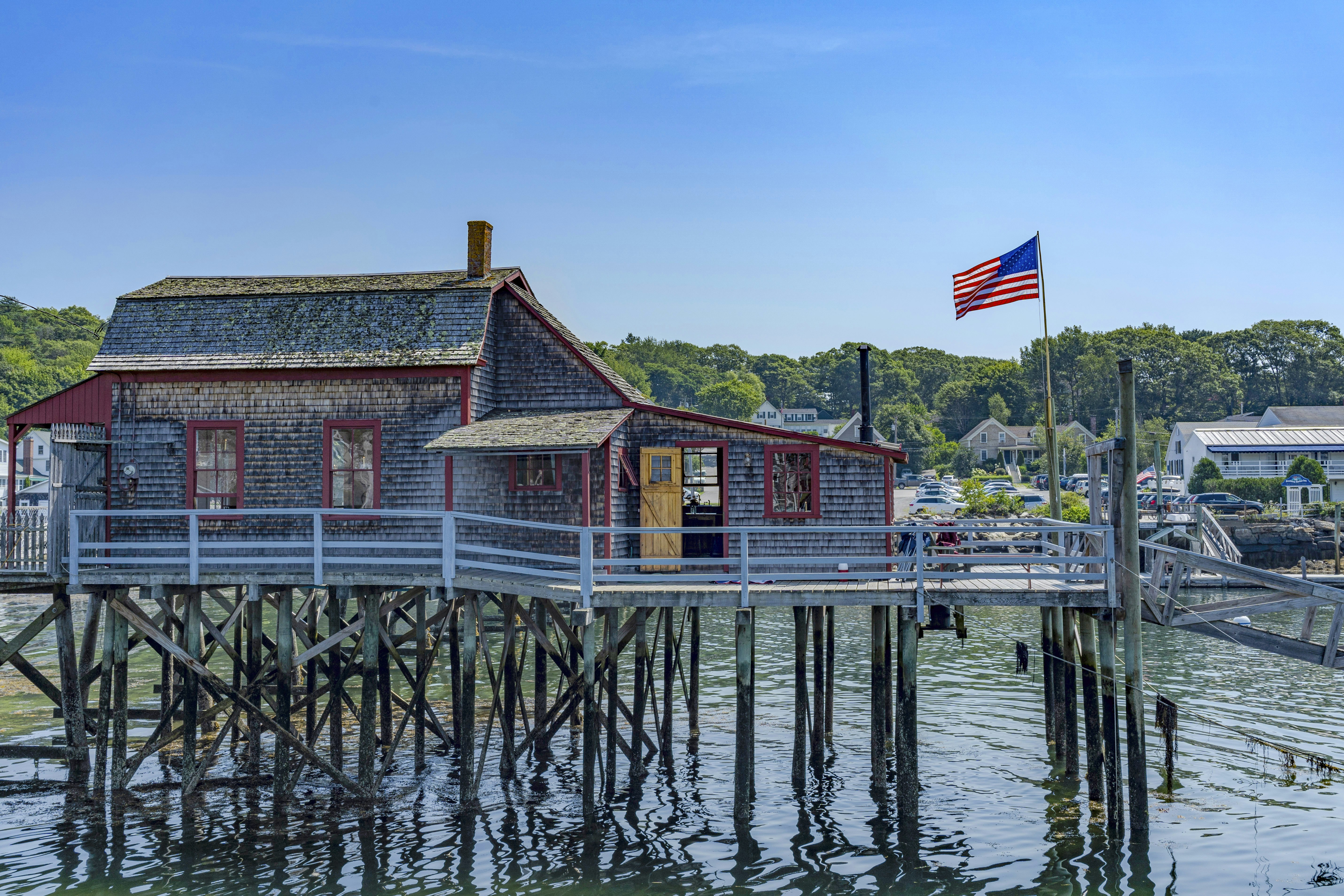brown wooden house on body of water during daytime
