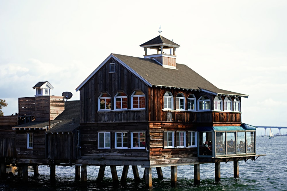 brown wooden house on water