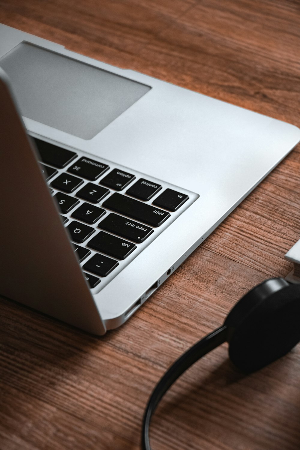 black and silver laptop computer on brown wooden table