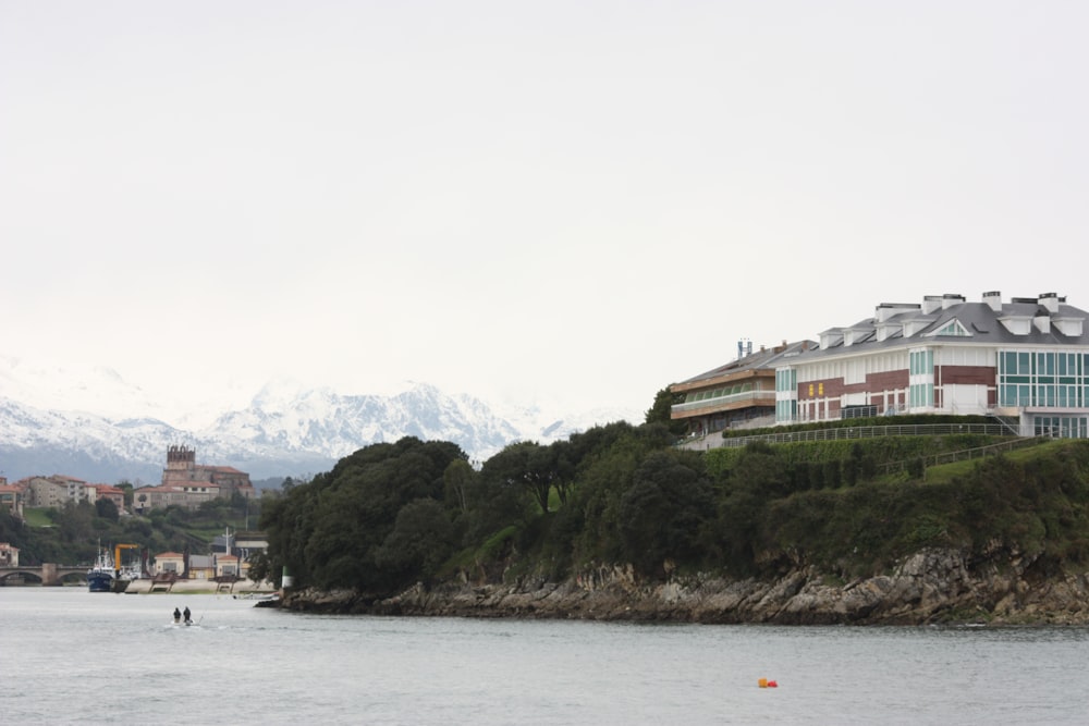 white and brown concrete building near body of water during daytime