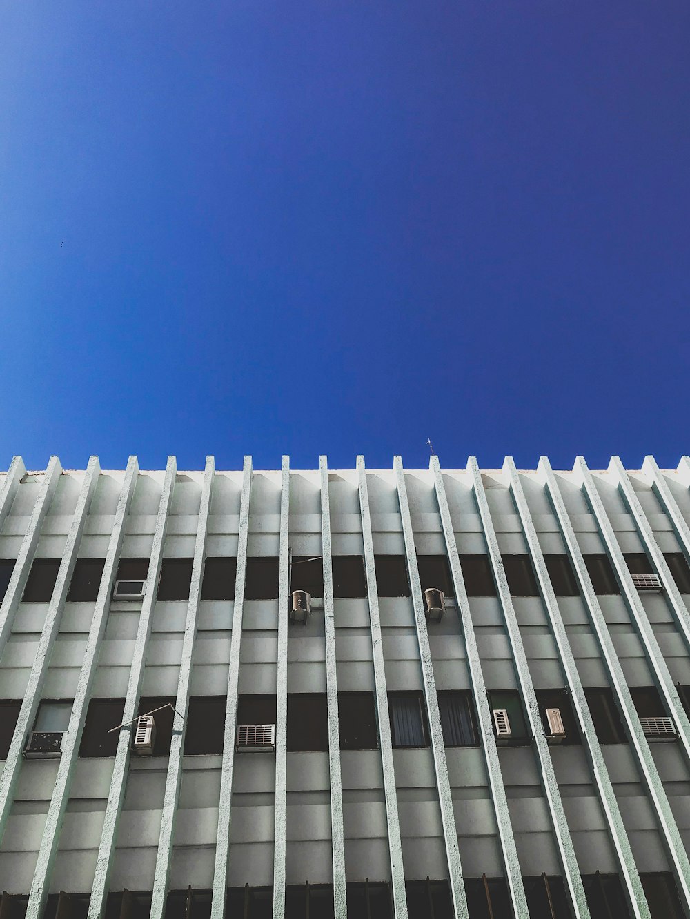 white concrete building under blue sky during daytime