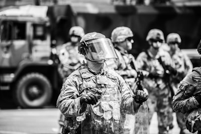grayscale photo of man in helmet and helmet