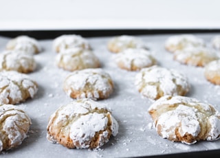 white and brown cookies on black tray