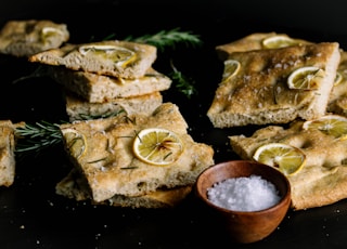 brown bread with sliced lemon on black surface